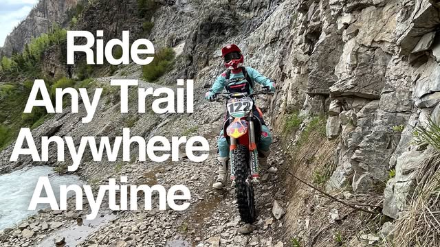 Rider on a narrow rocky canyon trail beside a river: Ride any trail anywhere anytime